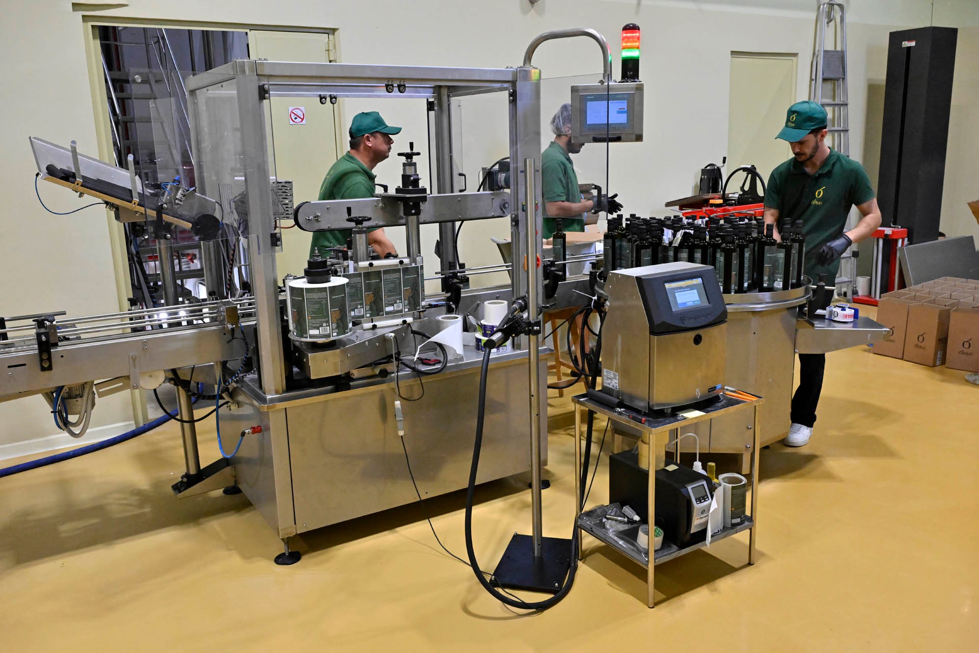 The labelling machine and the batch-code printer, bottles gathering on the rotary table