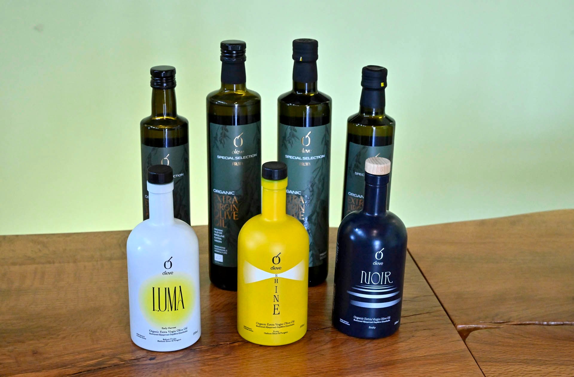 Ol-eve LUMA, SHINE and NOIR in front of four bottles of Ol-eve Special Selection