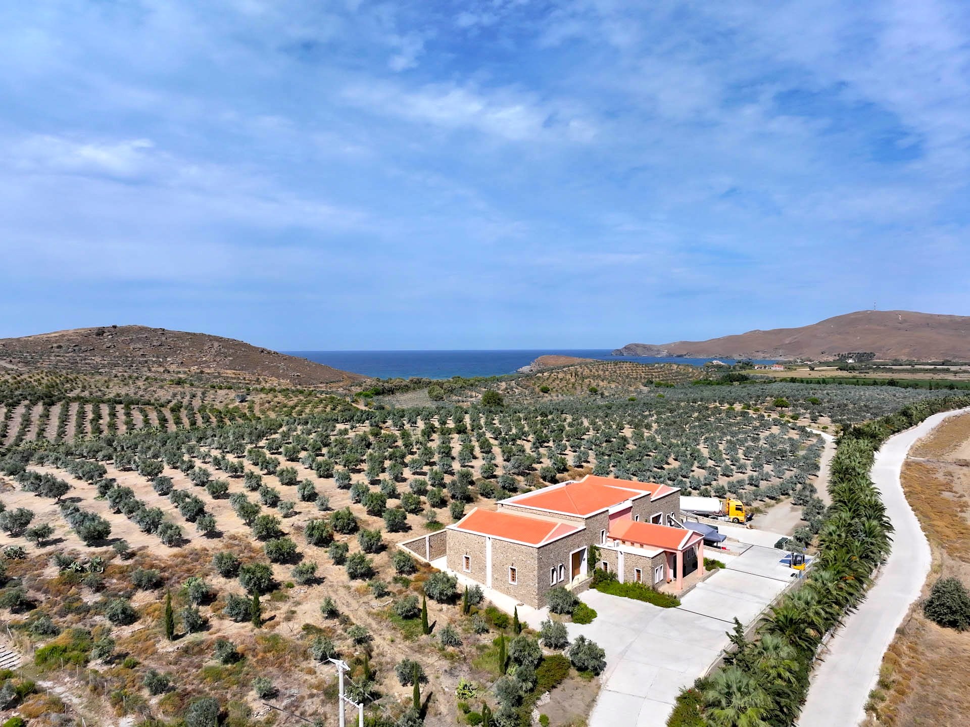 The mill, its olive groves and the sea on the horizon