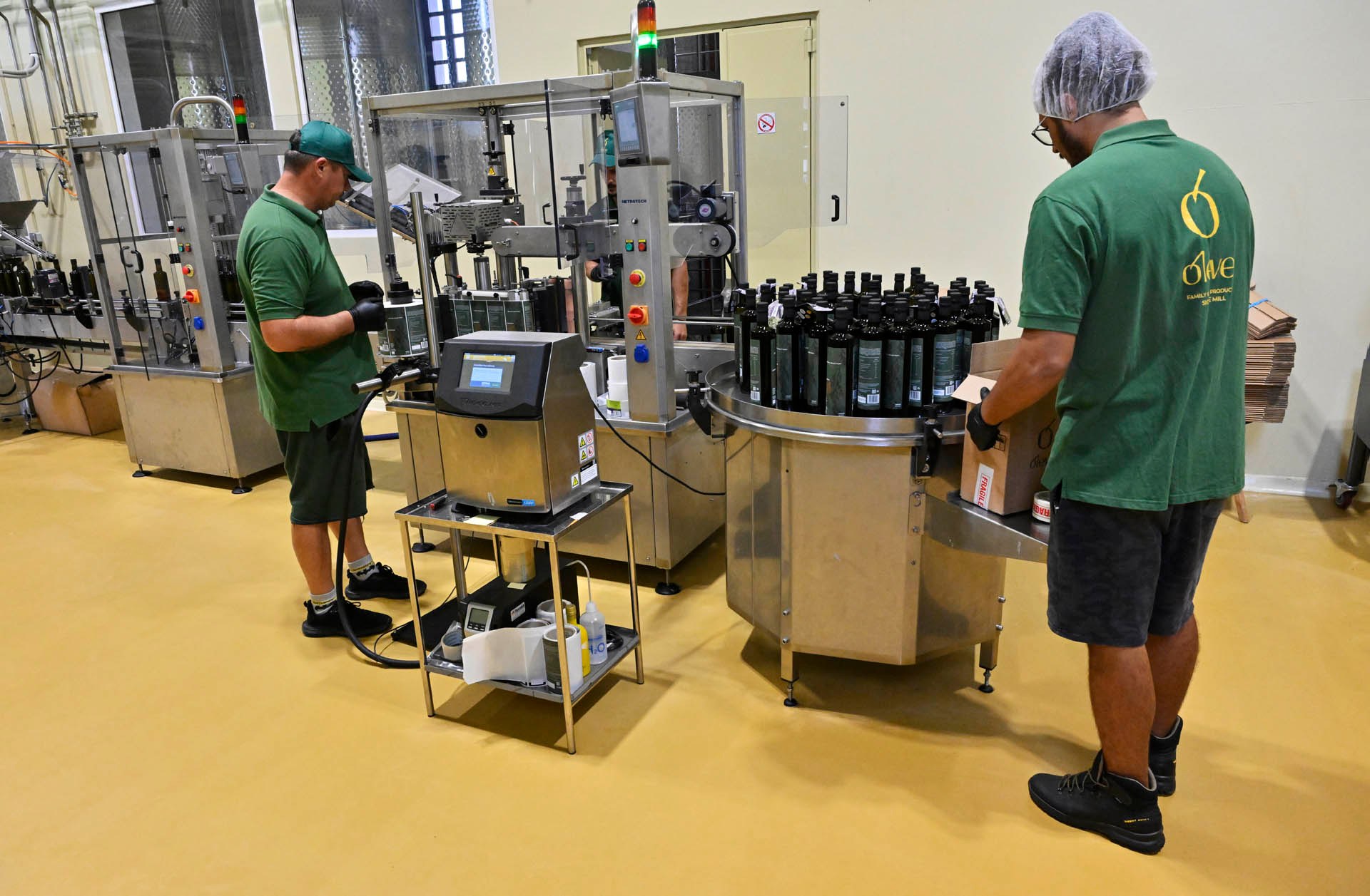 Bottles from the labelling machine, packed into cases by hand