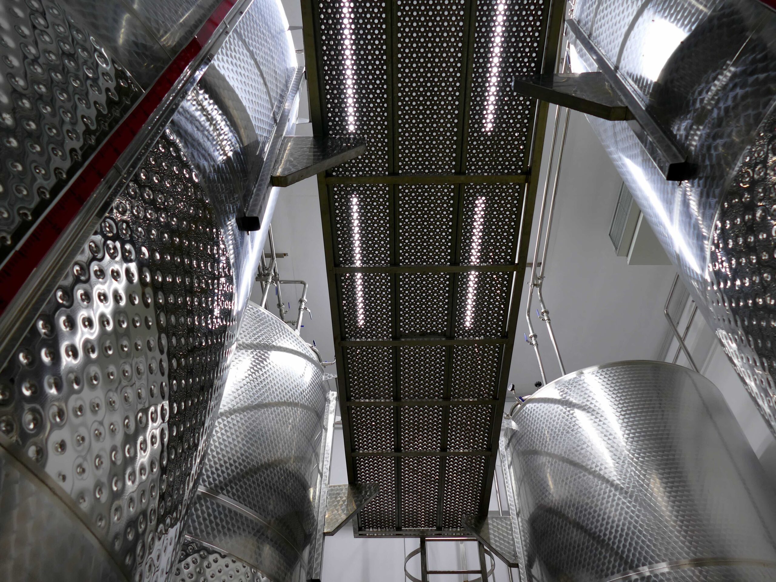 The steel walkway between the storage tanks, seen from below