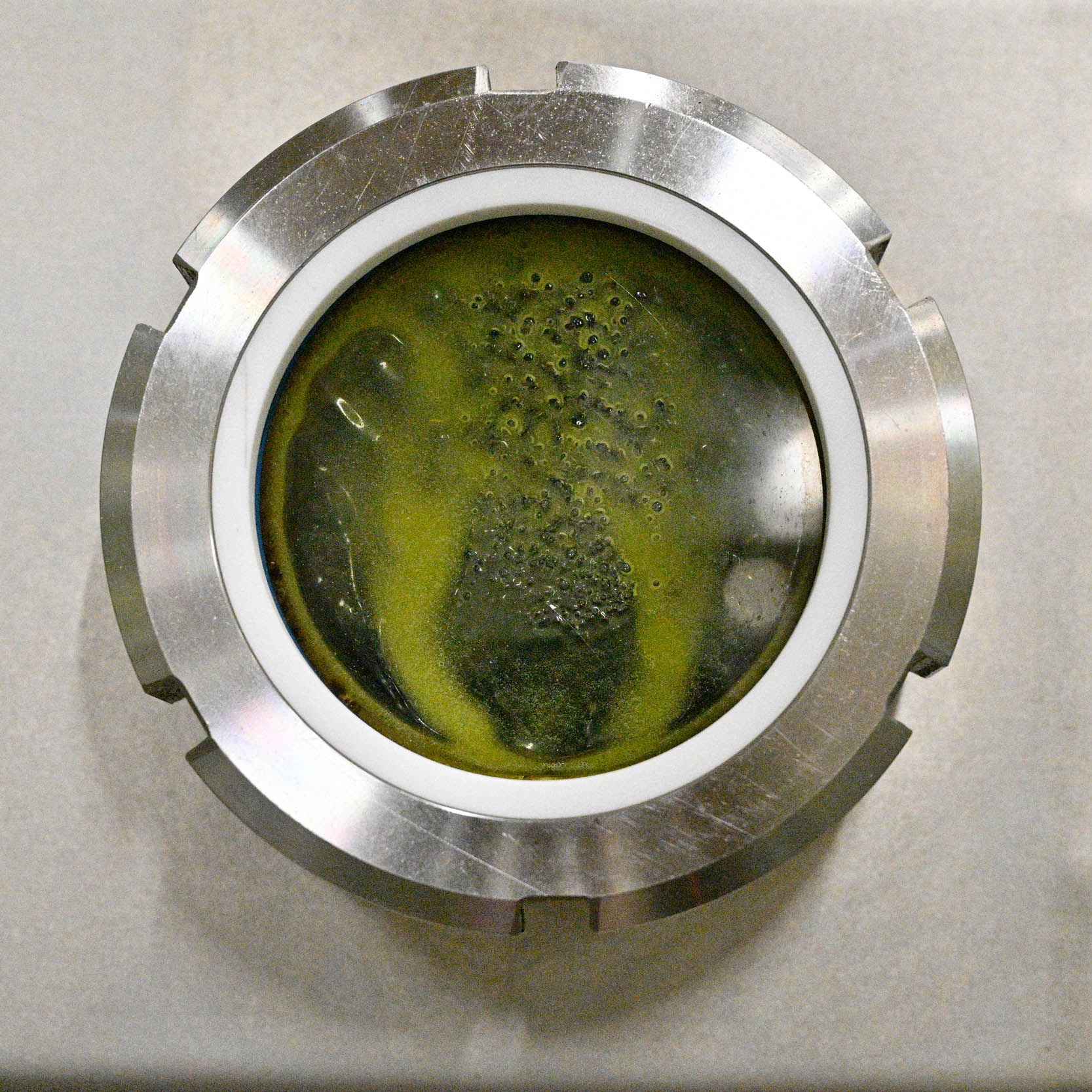 Olive paste behind the porthole of the closed circuit