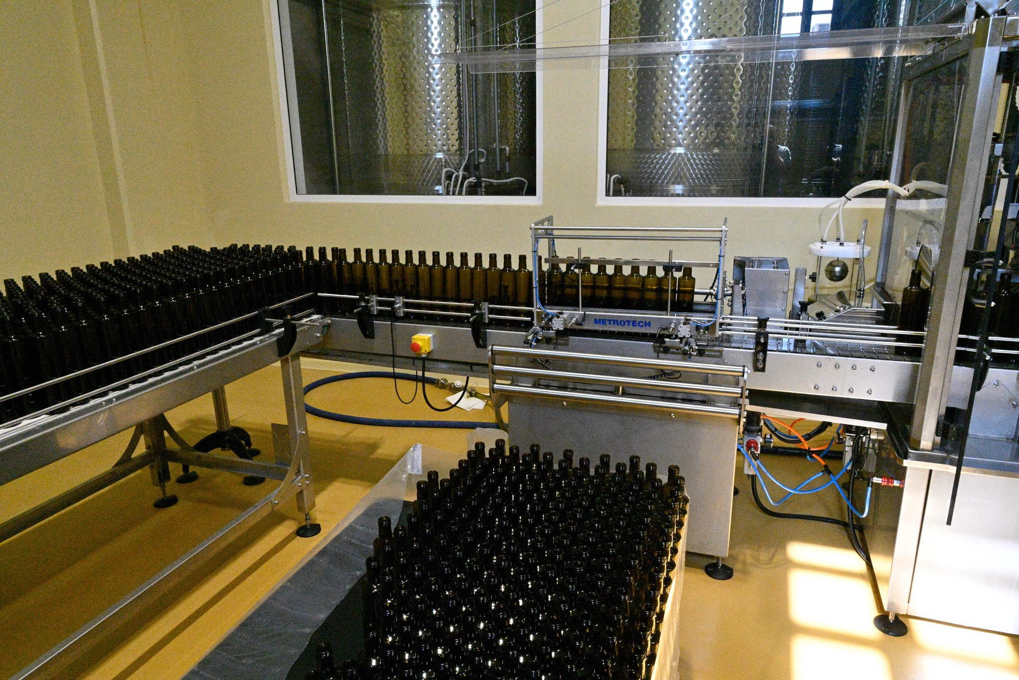 Empty dark glass bottles waiting on the bottling line